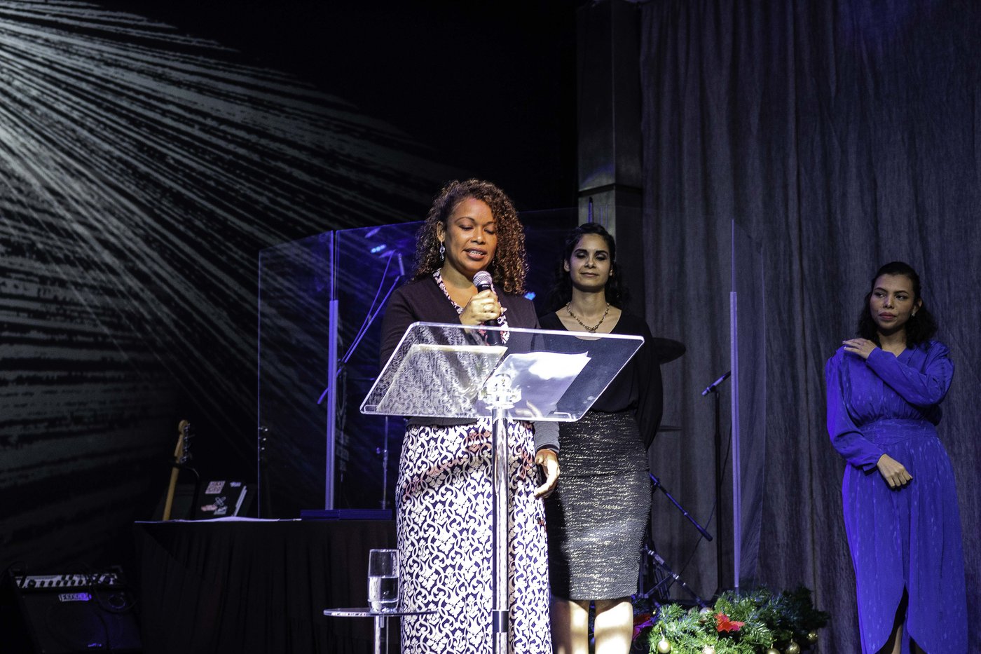 Mariela speaking from a church pulpit